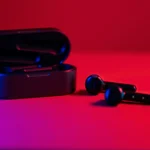 a close up of an earbud with a neon lit background