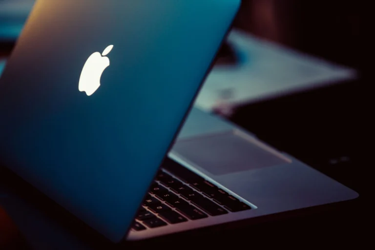 a blue laptop that is on top of a black table
