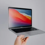 someone is holding up a laptop computer with the screen on