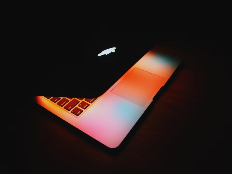 a colorful laptop in a dark room